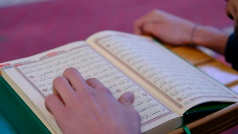 Young-Muslim-Wearking-A-Mask-Reading-The-Quran-In-Mosque