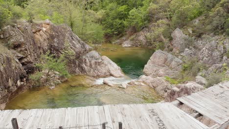 drone video flying over wooden bridge waterfall river mountain forest mount paiko