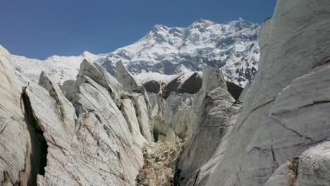 Aerial-shot-of-flying-through-the-glacier-canyons-with-Nanga-Parbat-in-the-background,-Fairy-Meadows-Pakistan,-cinematic-drone-shot