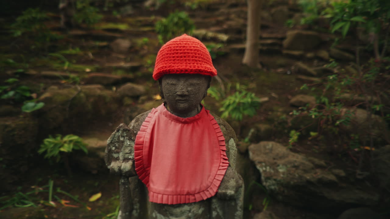 Jizo Statue with Red Hat and Bib in a Japanese Garden