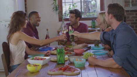 Six-young-adult-friends-making-a-toast-at-a-dinner-party,-shot-on-R3D