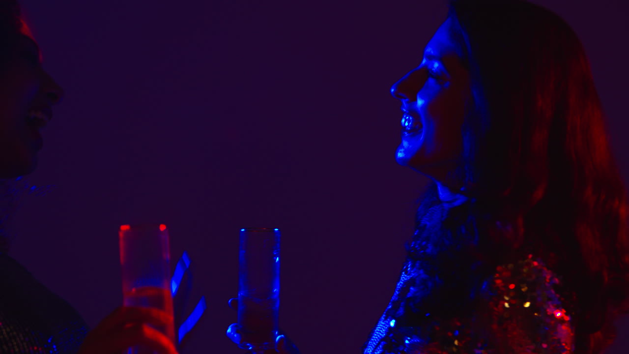 Close Up Of Two Women In Nightclub Bar Or Disco Dancing And Drinking Alcohol 3
