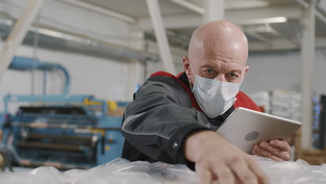 factory worker checking produced polythene