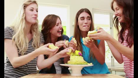 Happy-friends-eating-cake-with-hands