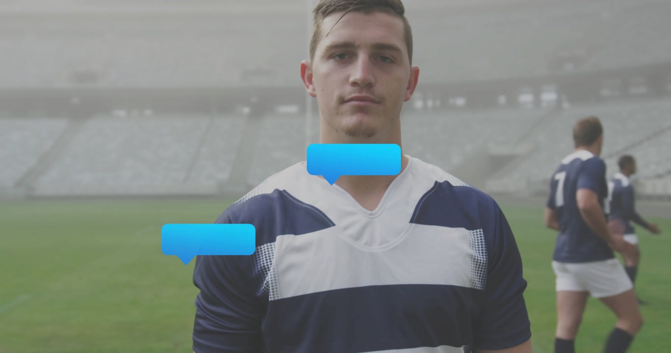 Facing rugby player in navy jersey reacting to blue bubble appearing, chat dots forming on pitch