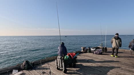 people fishing on a pier in melbourne