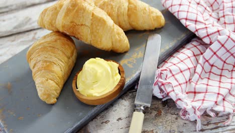 croissants with butter and knife