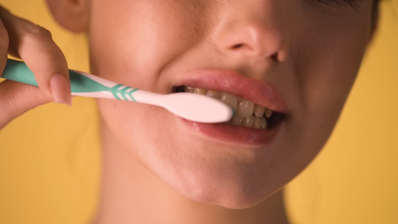 Caucasian Girl Brushes her White Teeth Closeup Chroma Background Beautiful Skin Mouth, Lips and Face Closeup, Healthy Habit