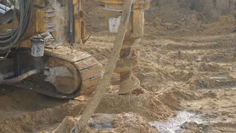 equipment for installing piles in ground, heavy machines for driving pillars work in laying the foundation building. construction aerial view height. construction site drilling pile foundation.