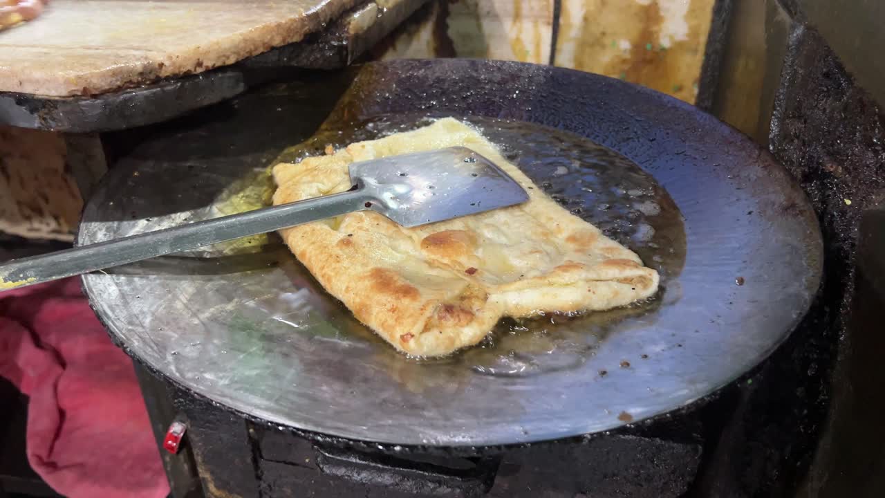 Delicious appetizer fried Moghlai paratha with egg and chicken in a restaurant in Kolkata, India.