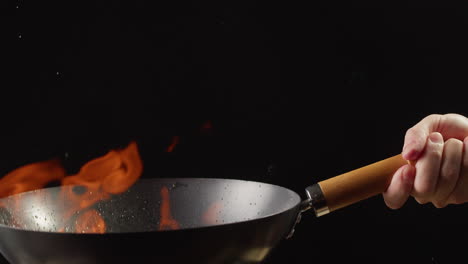 wok cooking with flames