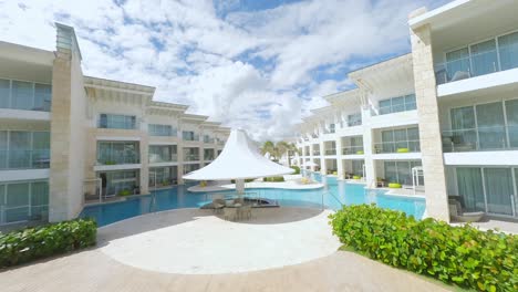 aerial drone fpv flying at low altitude over gardens and incredible pool of luxury nickelodeon resort at punta cana in dominican republic