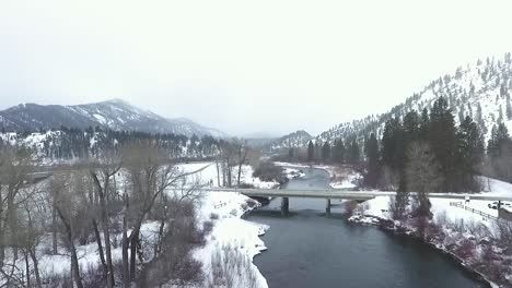 aerial - drone fly's towards bridge above a river