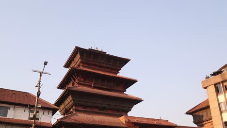 tall pagoda style temples in durbar square in kathmandu, nepal at the base of the himalayas