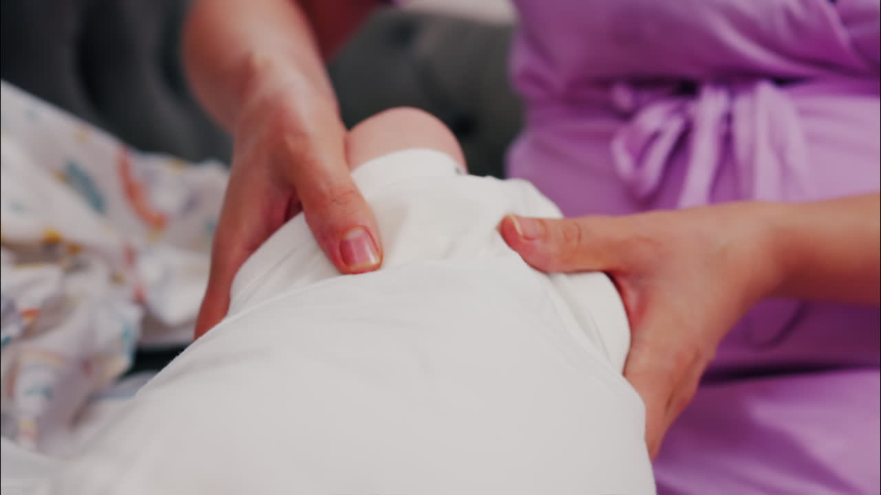 Close up of a mother doing mobility exercises with her baby