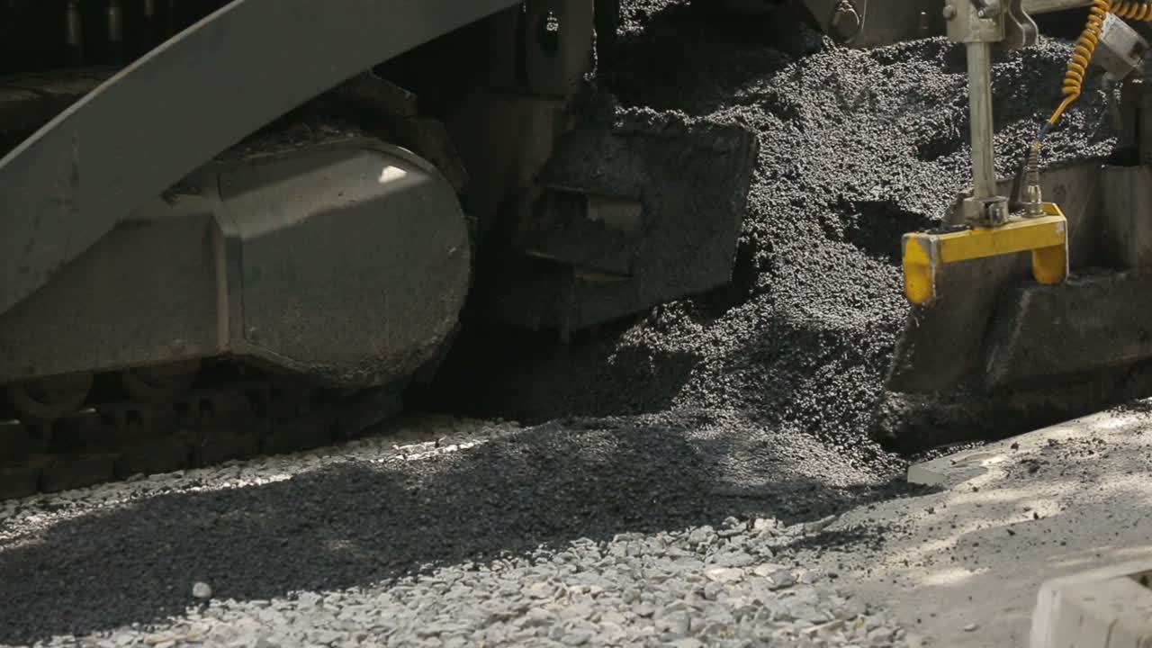 Construction And Repair On The Road. Tracked paver at asphalt pavement works for road under construction
