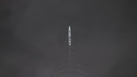 bird's eye view of boat sailing in laguna negra, colombia - aerial drone shot