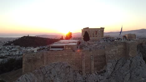 Athens-Acropolis-and-Parthenon-at-sunset-with-city-skyline-in-the-horizon,-Aerial-view