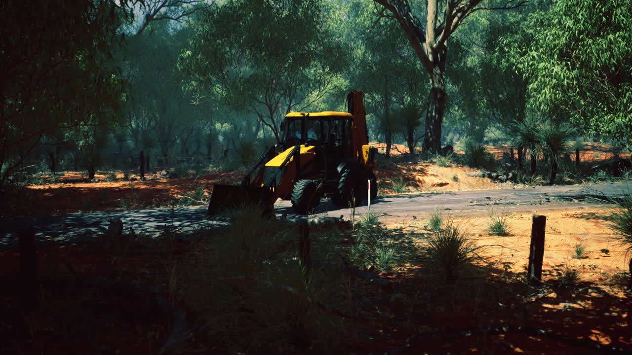 Tractor navigating through a sun drenched forest in the australian countryside