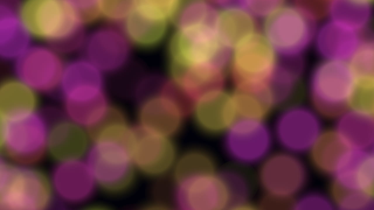 círculos púrpuras y verdes borrosos sobre un fondo negro