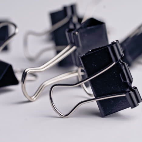pile of metal binder clips. office supplies