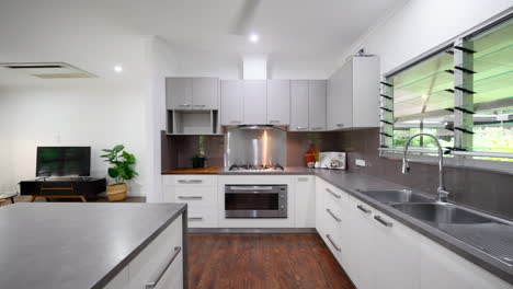 modern luxury kitchen dolly along island with grey and stainless steel cabinets and chopping block