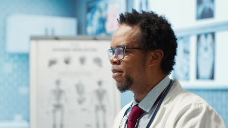 portrait of specialist with medical disposable gloves examining a patient in cabinet