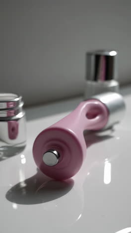 skincare products and beauty device on a white surface