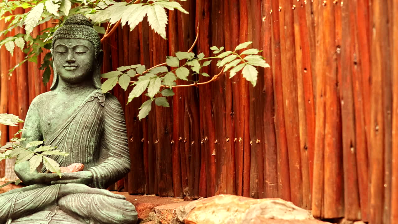 Buddha statue in Zen garden, relaxation and mindfulness - zooming in