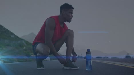 animación de rastros de luz azul contra afroamericano hombre en forma atando cordones de zapatos en la carretera