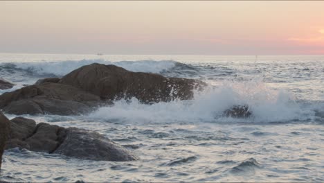 water splashes on rocks during sunset on a beach in portugal 4