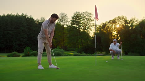 sport men play golf game on field. golfing team spend time on luxury resort.