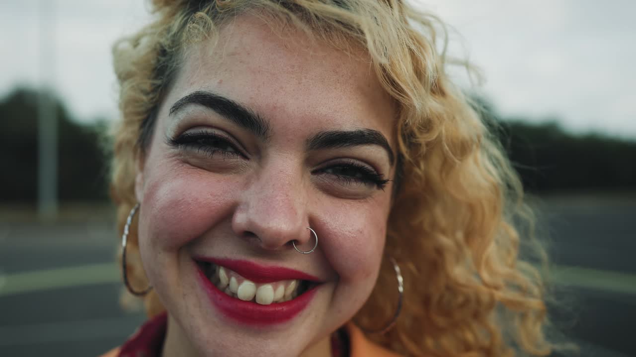 Happy young girl smiling in front of camera outdoor