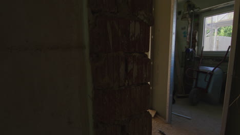 tracking shot near a brick wall entering a room with a steel girder and a lot of additional support pillars