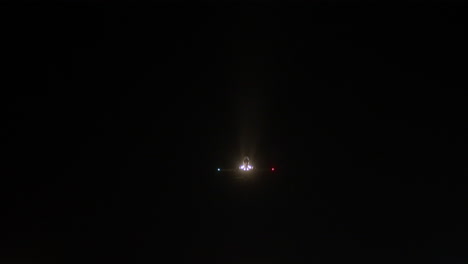 an airplane takes off in the dark sky