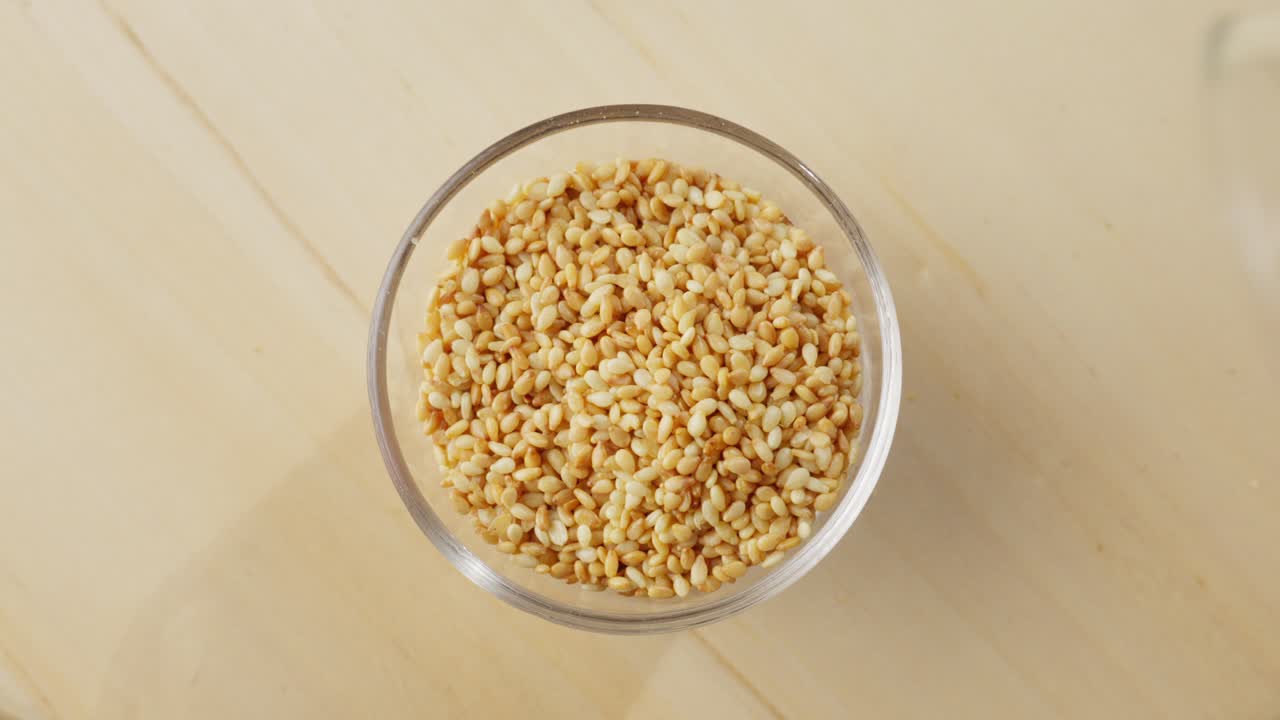 Slow motion shot of Korean sesame seeds falling gracefully