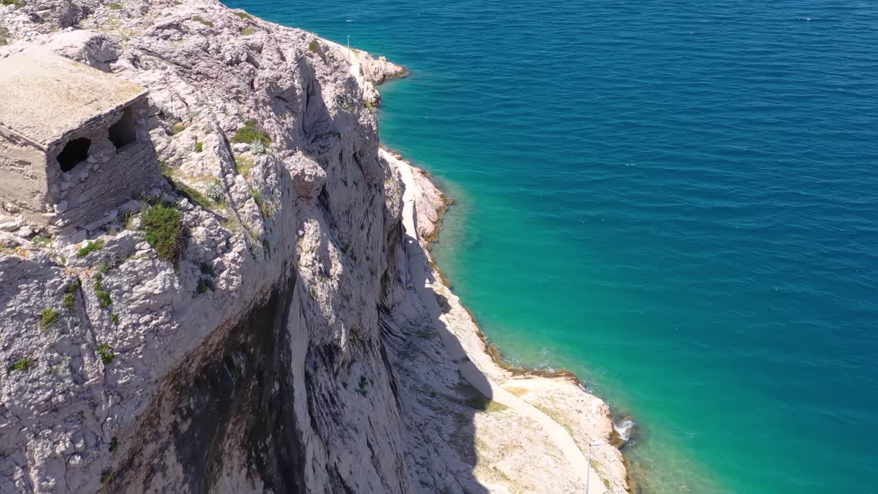cliffs and scenic walkway along the Adriatic sea, Pag Island.Aerial dolly out