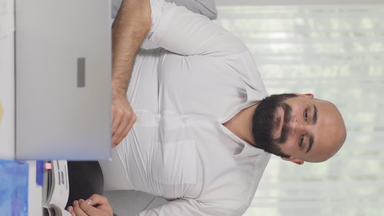 Vertical video of Home office worker man's hands are shaking.