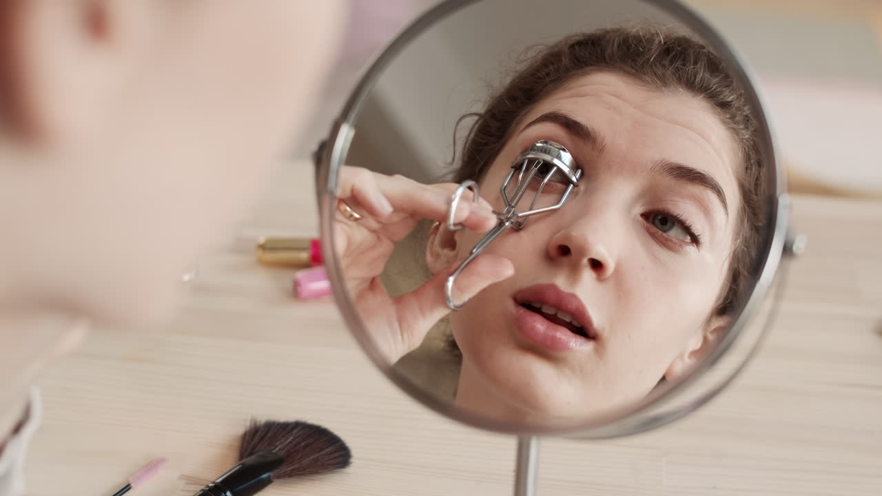 Woman Using Eyelash Curler