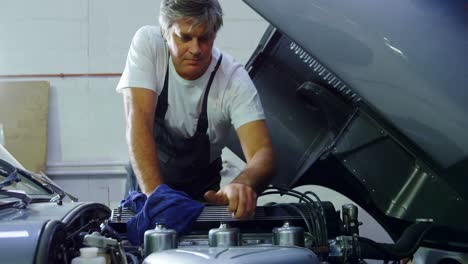 Male-mechanic-servicing-a-car-4k