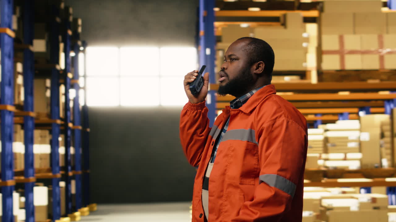 African american worker transmitting information via walkie-talkie radio signal
