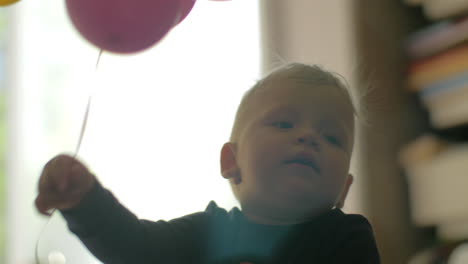 one year old baby girl with balloons