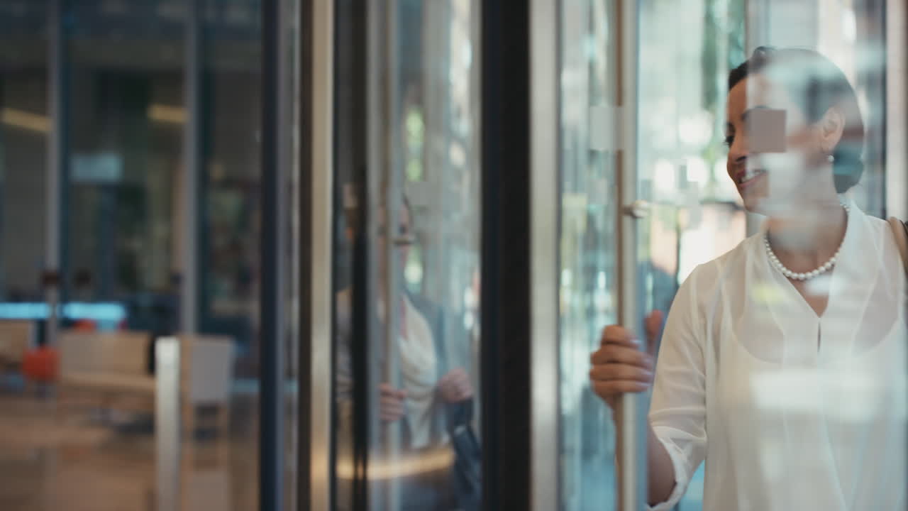 Businesswoman Entering a Modern Building