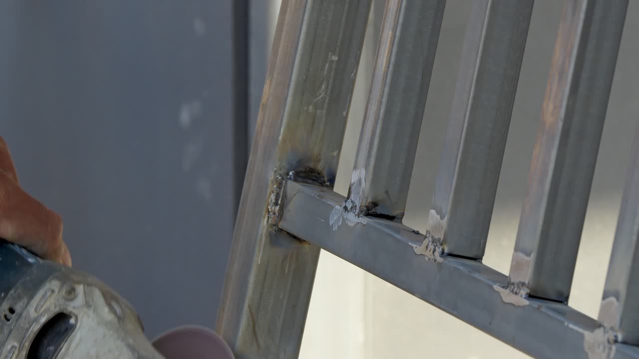 A skilled worker uses a cutting tool to shape metal components showcasing craftsmanship in a bustling construction site