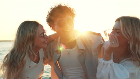 friends enjoying a sunset by the lake