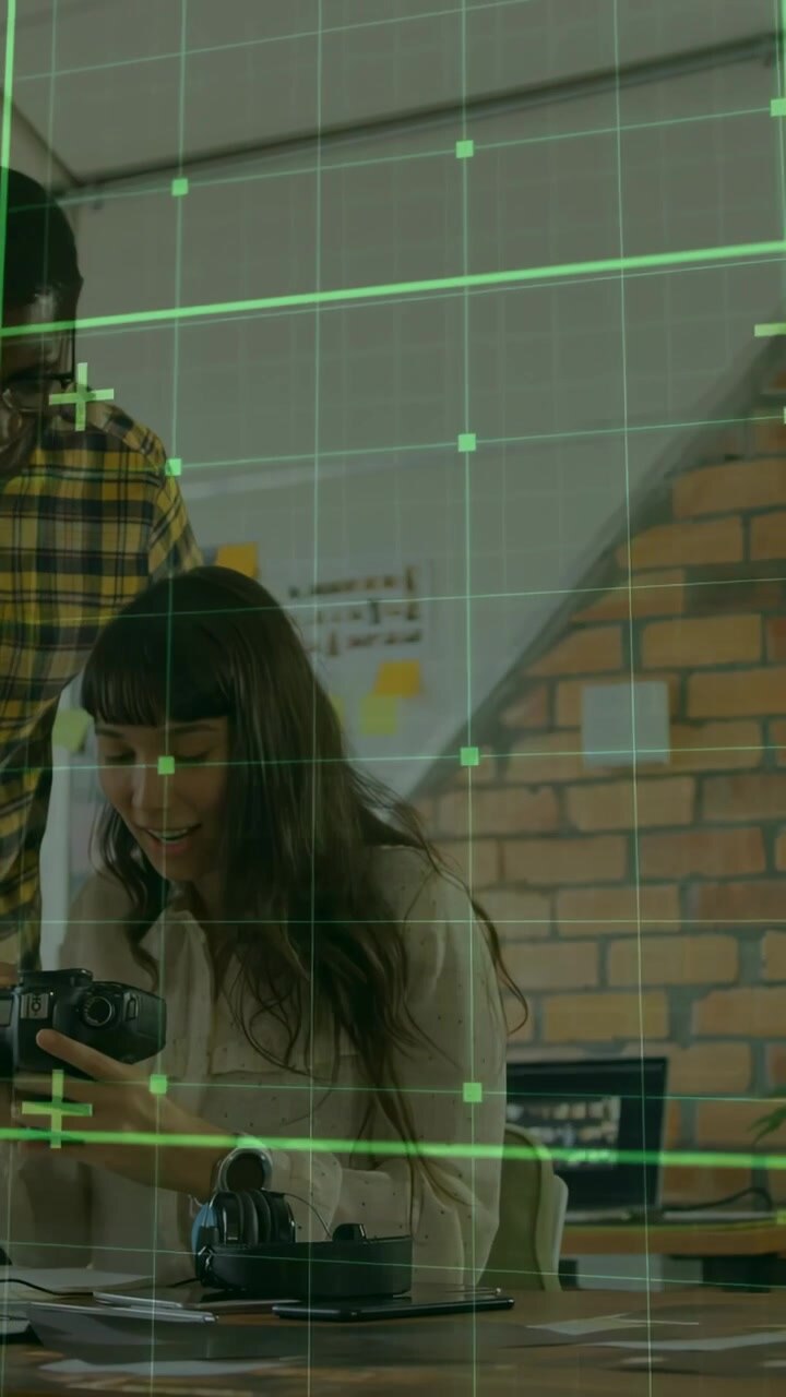 Vertical video: Woman tuning DSLR gear man guiding green grid showing photography settings