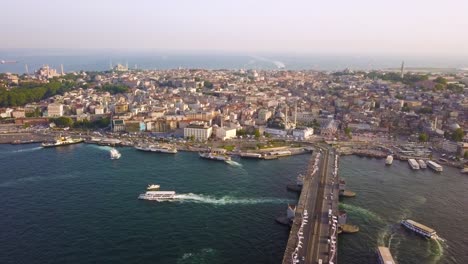 Aerial-tracking-shot-of-ship-that-passed-under-Galata-Bridge,-Istanbul