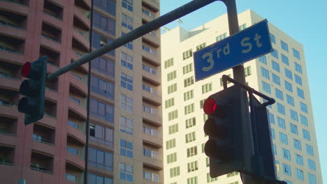 Traffic-regulation-signs-hanging-over-road-on-cityscape-background-close-up