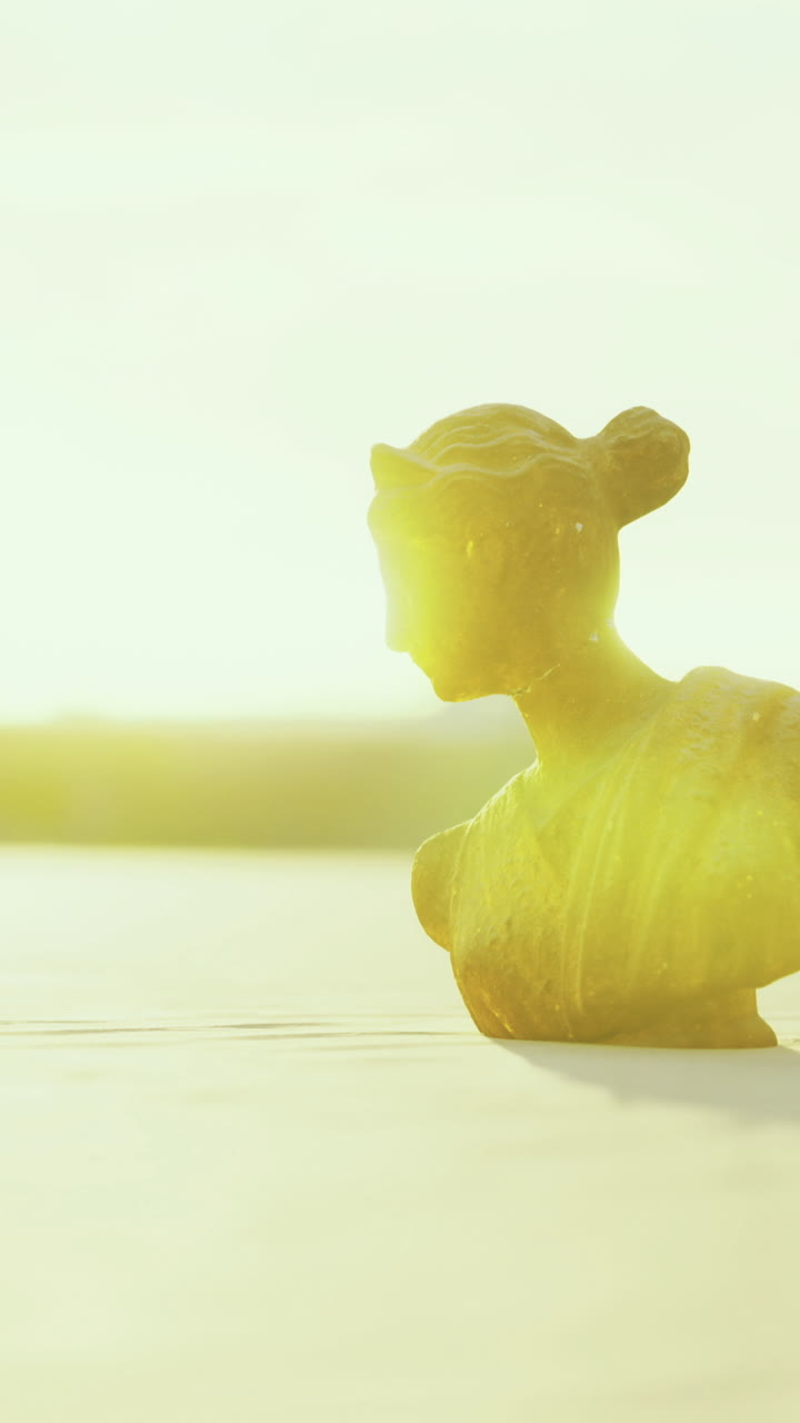 Bright sunlight illuminating a small sculpture in an outdoor setting