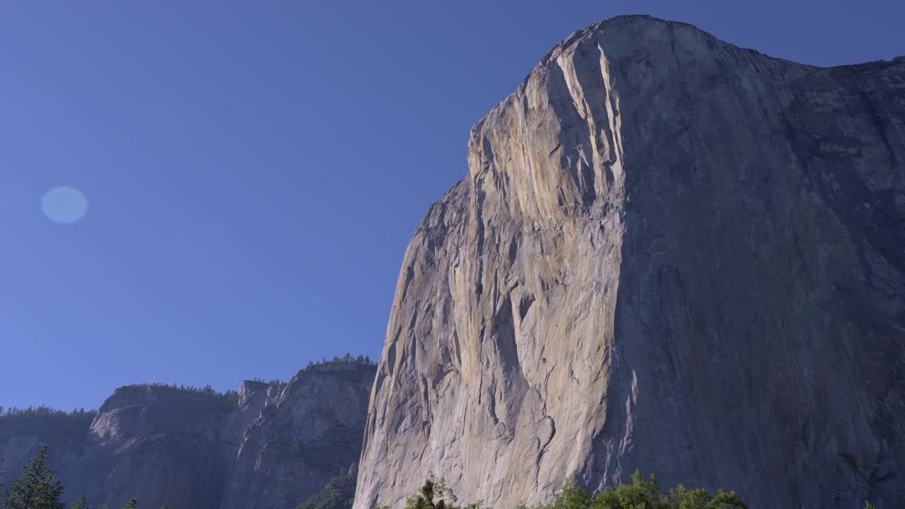 Editorial footage of a pan shot capturing the towering granite monolith El Capitan in Yosemite National Park, California.